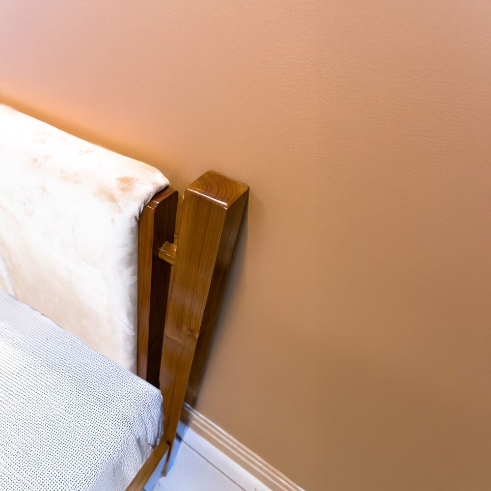The Minimalist Solid Wooden Bed features solid teak wood, a soft touch headboard, and a natural satin finish for timeless bedroom elegance.