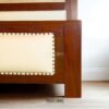 The Rattan Wooden Bed combines teak wood strength, woven rattan texture, and a soft headboard with satin finish for elegant comfort.
