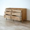 The Rustic Farmhouse Style Sideboard features teak wood, woven rattan surface, and six drawers, combining rustic charm with functional storage solutions.