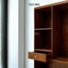 The Open Wardrobe with Drawer, made of teak wood with satin finish, offers stylish open storage and practical drawer functionality.