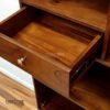 The Open Wardrobe with Drawer, made of teak wood with satin finish, offers stylish open storage and practical drawer functionality.