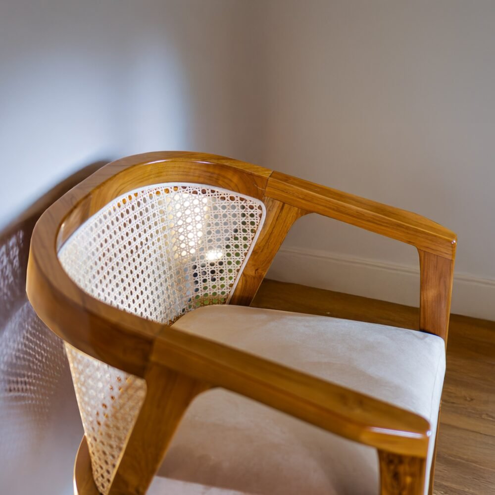 Experience elegance and comfort with the Rattan Dining Wood Chair, featuring teak wood, rattan accents, and cushioned seating for timeless interiors.