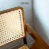 Enhance your dining space with the Natural Rattan Dining Chair, featuring a teak wood frame, woven rattan seating, and satin finish.