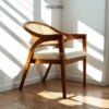 Experience comfort and style with the Scandinavian Rattan Dining Chair, featuring teak wood frame, rattan backrest, soft foam cushions, and satin finish.