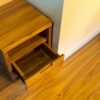 Elevate your space with the Elegant Teak Nightstand, featuring a single drawer, open shelf, and natural satin wood finish.