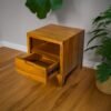 Elevate your space with the Elegant Teak Nightstand, featuring a single drawer, open shelf, and natural satin wood finish.