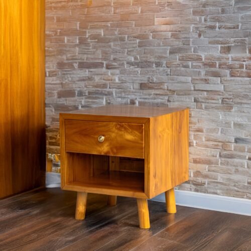 Enhance your space with The Single Drawer Teak Nightstand, featuring solid teak wood, natural satin finish, and a practical open drawer design.
