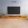 The Minimalist Wooden TV Cabinet, crafted from teak wood with satin finish, features nine drawers and modern design for elegant media storage.