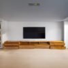 The Minimalist Wooden TV Cabinet, crafted from teak wood with satin finish, features nine drawers and modern design for elegant media storage.