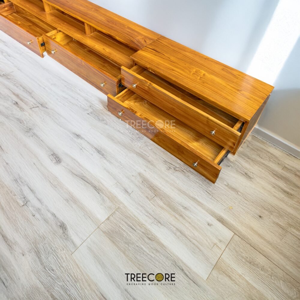 The Minimalist Wooden TV Cabinet, crafted from teak wood with satin finish, features nine drawers and modern design for elegant media storage.